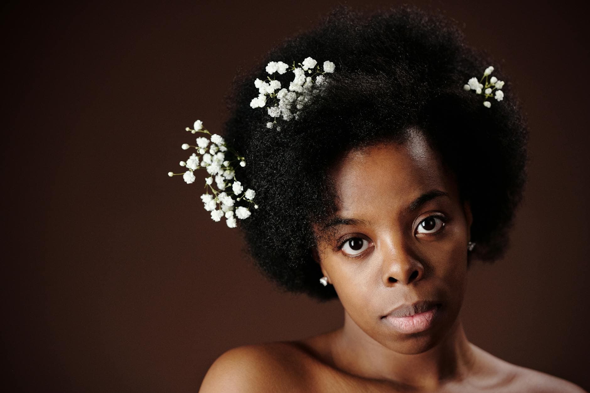 A diverse group of individuals with natural textured hair engaged in a skincare routine, showcasing the importance of melanin in enhancing beauty and skin health.